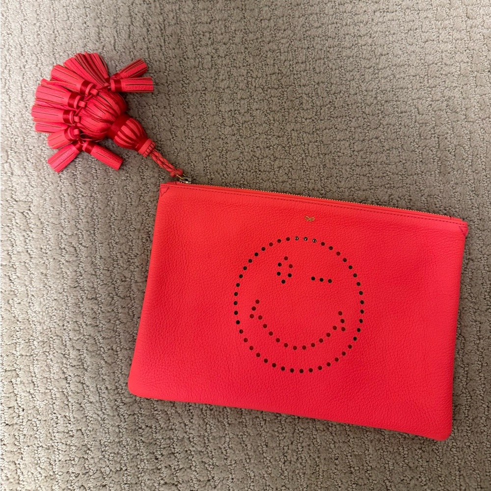 Anya Hindmarch bright orange smiley face clutch
